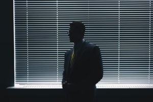 man standing in a shaded room