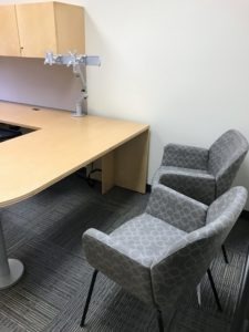 Blue Office Chair and Light Brown Desk Delivered by Marathon Building Environments