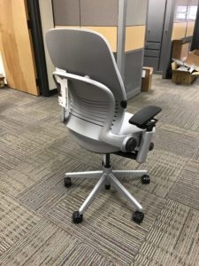 Office Chair Delivery. A silver chair with black armrest. Pick a design that works with your home or office space.