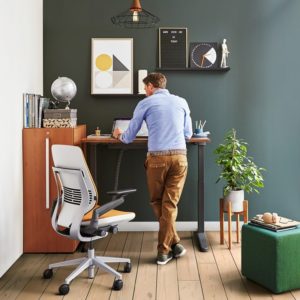 man in private office with a standing desk