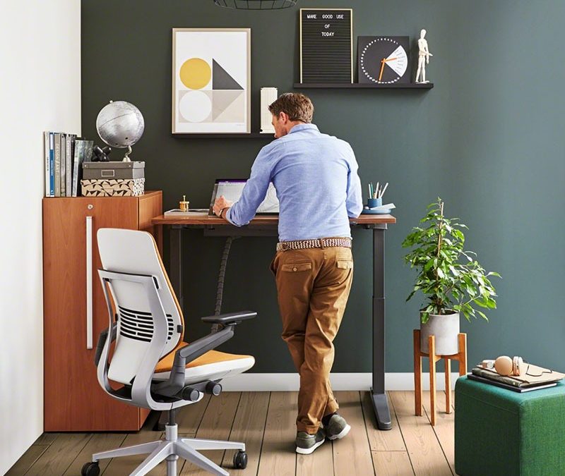 man in private office with a standing desk