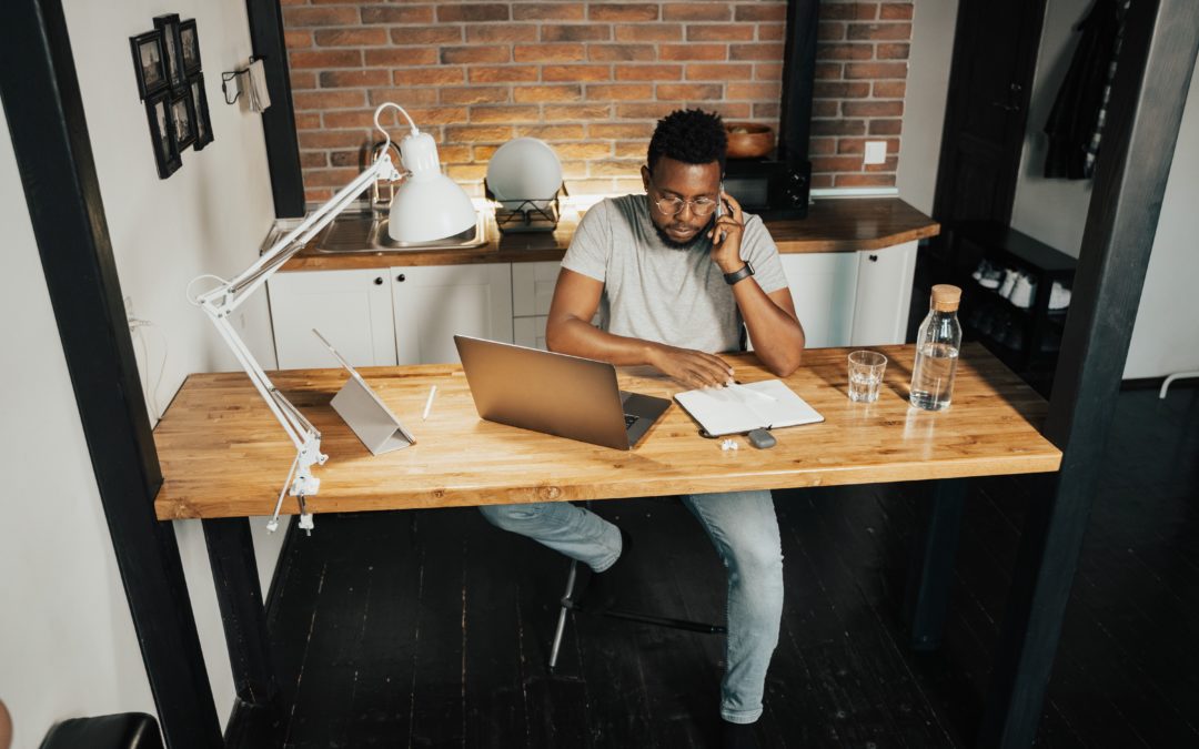man working from home at wooden desk