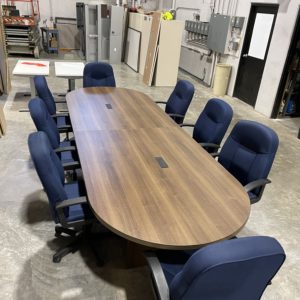 Large maple conference table with blue office chairs