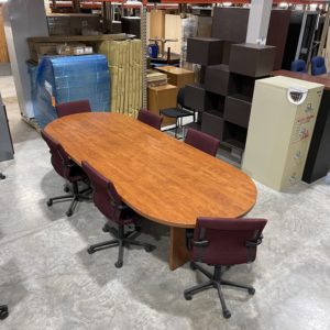 large cherry conference room table with deep red office chairs