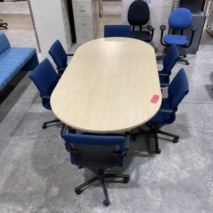 medium sized office conference table with blue steelcase chairs