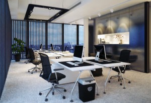desks and chairs set up in an office with commercial office blinds in the windows
