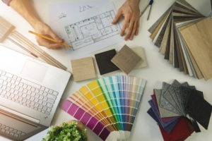 designer working in office doing furniture and flooring material selection from samples for how to manage an interior design project