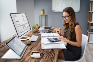 Accountant at desk determining can you write off office furniture