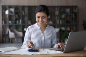 woman at desk deciding how to save money on office furniture