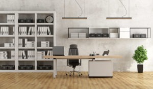 Black and white modern office with desk and bookcase to show Why it's worth investing in the perfect desk