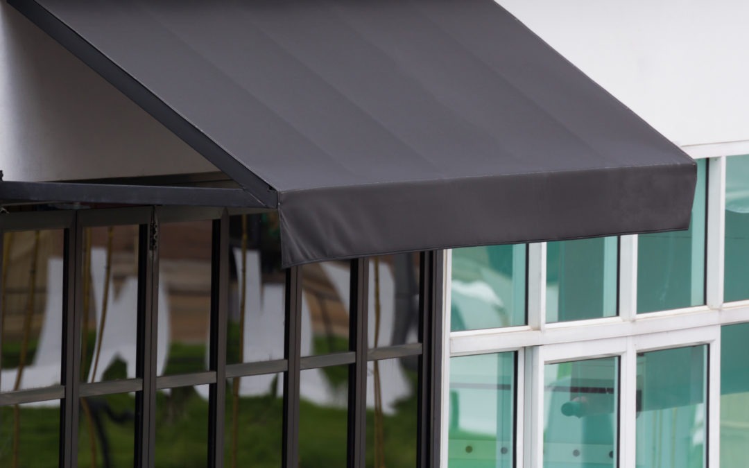 close up of black exterior commercial awnings on business storefront