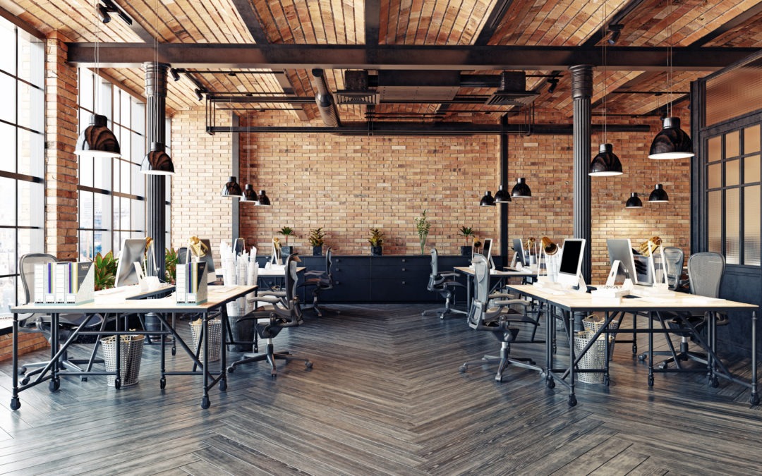 a modern office design featuring desks in a brick room with natural lighting