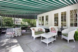 Patio in luxury home with green residential awning