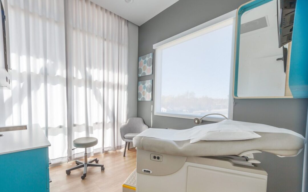 patient room at a doctors office that is peaceful and serene with blue and gray color scheme healthcare interior design