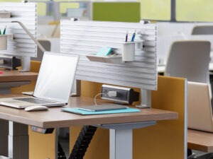 steelcase slatwall office oraganization system set up on the wall behind an office desk