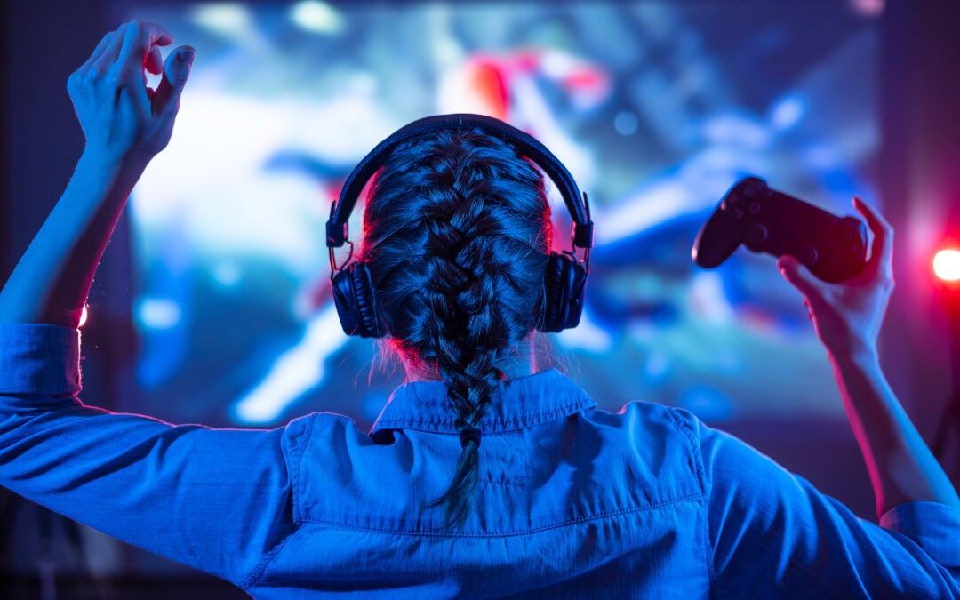Young girl in headphones plays a video game on the TV in the evening and showing gaming ergonomics