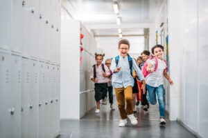 children running through the hallway of a school with concrete flooring for schools