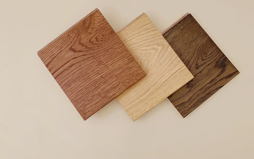 flooring samples laid out on a tan background to show engineered vs solid hardwood
