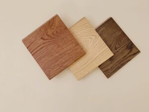 flooring samples laid out on a tan background to show engineered vs solid hardwood