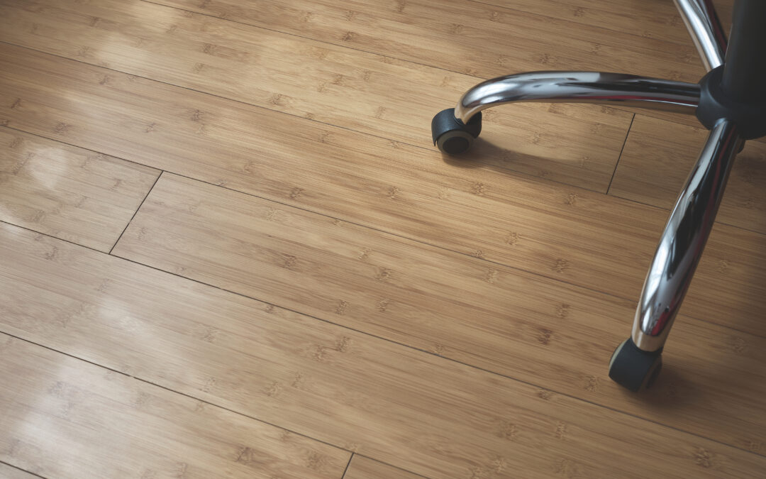 wheels of an office chair on a hard wood floor that is on trend with flooring trends