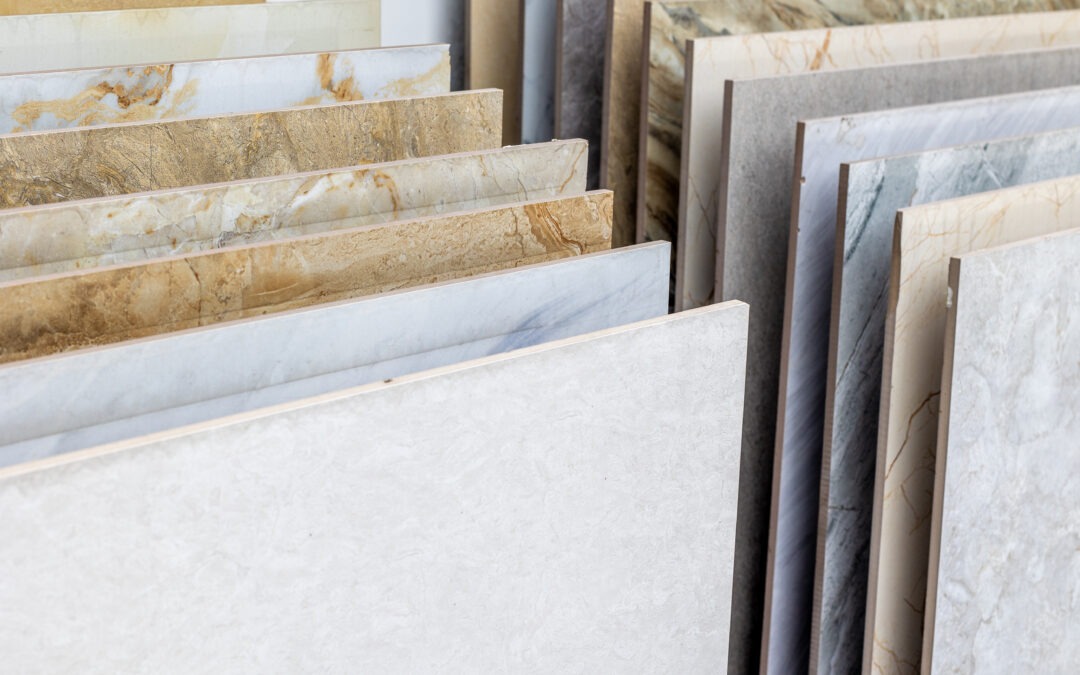 Variety of marble and granite stone slabs displayed in a store for commercial flooring, commercial grade carpet, commercial grade tile