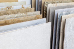 Variety of marble and granite stone slabs displayed in a store for commercial flooring, commercial grade carpet, commercial grade tile