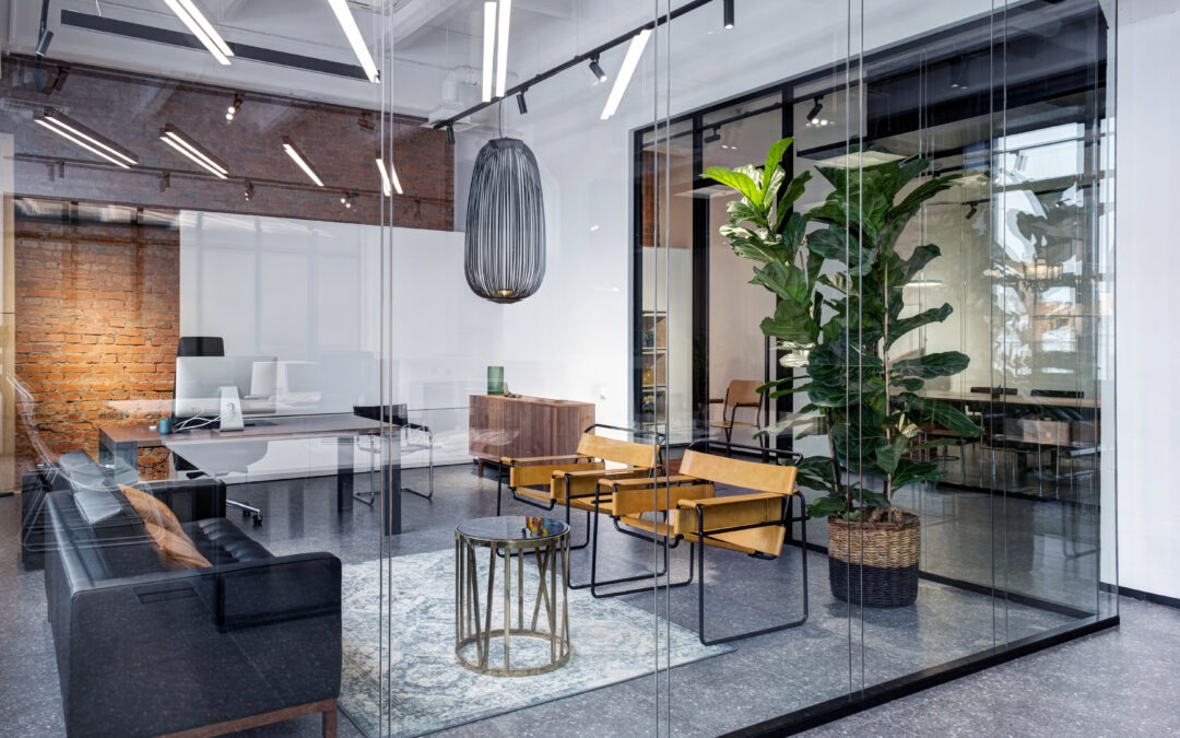 Interior meeting room in modern space office with a brick walls and wooden computer desks. View through glass partition showing office furniture trends