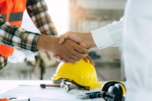 commercial flooring contractor shaking hands with business owner