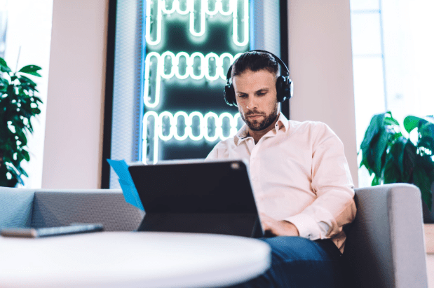 man in workplace wearing noise canceling headphones